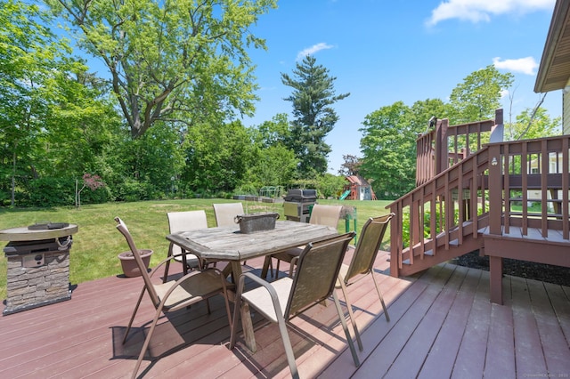 25 Parkwood Ave, Waterbury, CT 06708 - deck featuring a playground, a yard, outdoor dining area, and a fire pit