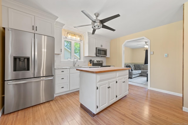 25 Parkwood Ave, Waterbury, CT 06708 - kitchen featuring stainless steel appliances, ceiling fan, light wood-style flooring, and white cabinetry