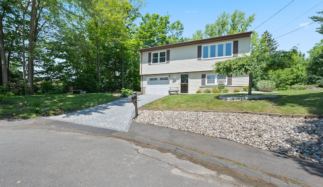 25 Parkwood Ave, Waterbury, CT 06708 - view of front of house with driveway, a front lawn, and an attached garage