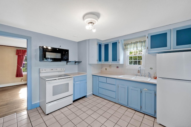 151 Mckee St, Manchester, CT 06040 - kitchen with white appliances, blue cabinetry, a sink, light countertops, and decorative backsplash
