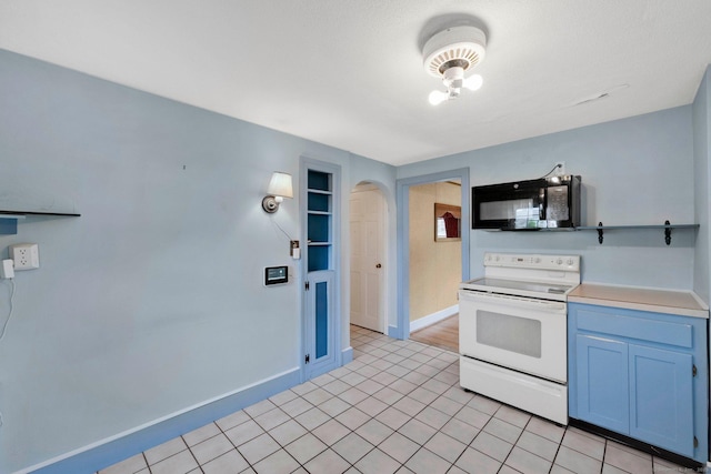 151 Mckee St, Manchester, CT 06040 - kitchen featuring electric range, black microwave, arched walkways, baseboards, and light countertops