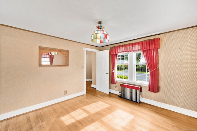 151 Mckee St, Manchester, CT 06040 - unfurnished room with radiator heating unit, wood finished floors, baseboards, and ornamental molding