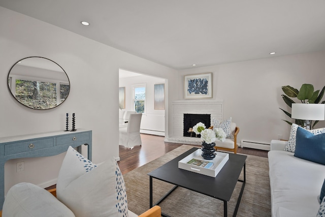 5 Edge Hill Trl, Westport, CT 06880 - living area featuring baseboard heating, a baseboard heating unit, wood finished floors, a brick fireplace, and recessed lighting