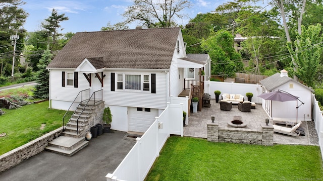 1 Freedman Dr, Norwalk, CT 06854 - view of front of house with an outdoor living space with a fire pit, asphalt driveway, an attached garage, a chimney, and an outbuilding