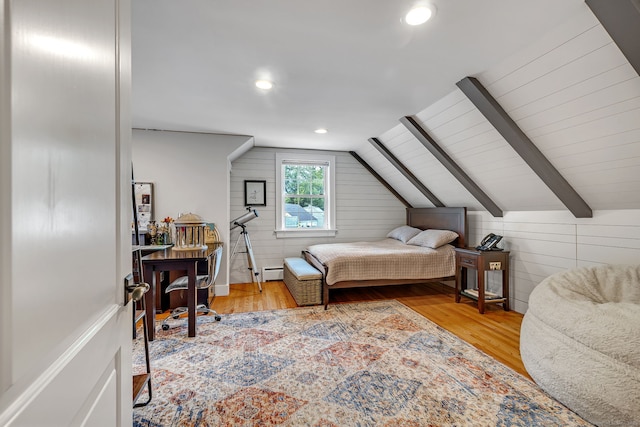 1 Freedman Dr, Norwalk, CT 06854 - bedroom with vaulted ceiling, wood finished floors, wooden walls, recessed lighting, and a baseboard heating unit
