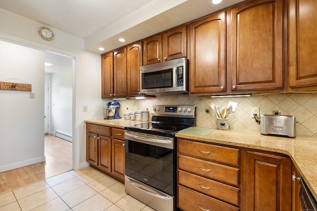 176 Prospect Hill Rd, Colchester, CT 06415 - kitchen featuring appliances with stainless steel finishes, a baseboard heating unit, decorative backsplash, light tile patterned flooring, and recessed lighting