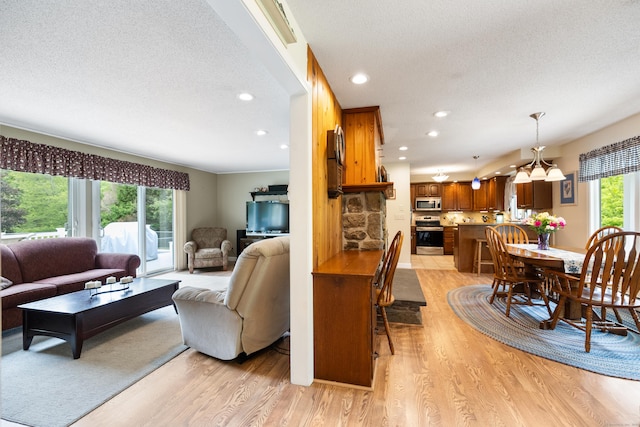 176 Prospect Hill Rd, Colchester, CT 06415 - living area with light wood-type flooring, a textured ceiling, recessed lighting, and a chandelier