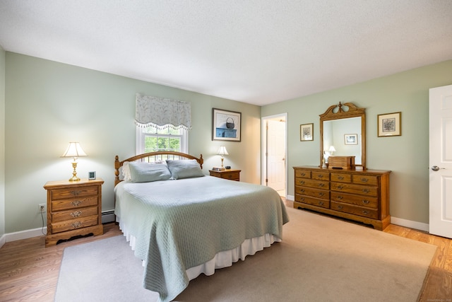176 Prospect Hill Rd, Colchester, CT 06415 - bedroom with light wood-style flooring, a baseboard radiator, and baseboards
