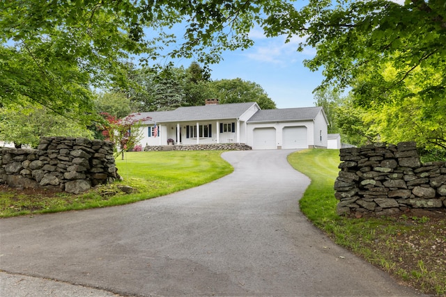 176 Prospect Hill Rd, Colchester, CT 06415 - ranch-style home with asphalt driveway, an attached garage, a porch, a front yard, and a chimney