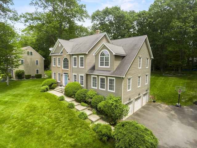 67 Melissa Ln, Prospect, CT 06712 - colonial house with a chimney, driveway, a garage, and a front lawn