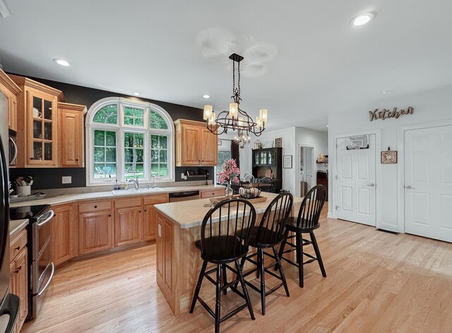 67 Melissa Ln, Prospect, CT 06712 - kitchen featuring stainless steel appliances, light countertops, light wood-type flooring, a breakfast bar, and recessed lighting