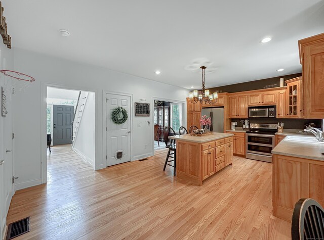 67 Melissa Ln, Prospect, CT 06712 - kitchen featuring appliances with stainless steel finishes, a breakfast bar area, light countertops, light wood finished floors, and recessed lighting