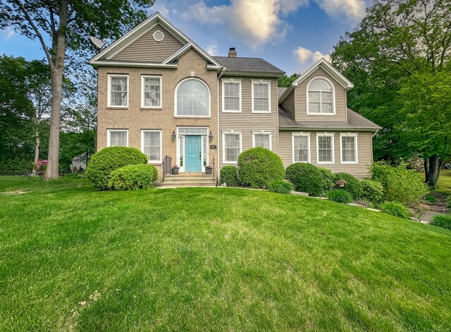 67 Melissa Ln, Prospect, CT 06712 - colonial house featuring a front yard and a chimney
