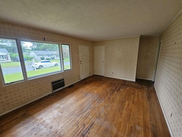 30 Hardwood Rd, Plainville, CT 06062 - unfurnished room with wallpapered walls, hardwood / wood-style floors, and baseboards