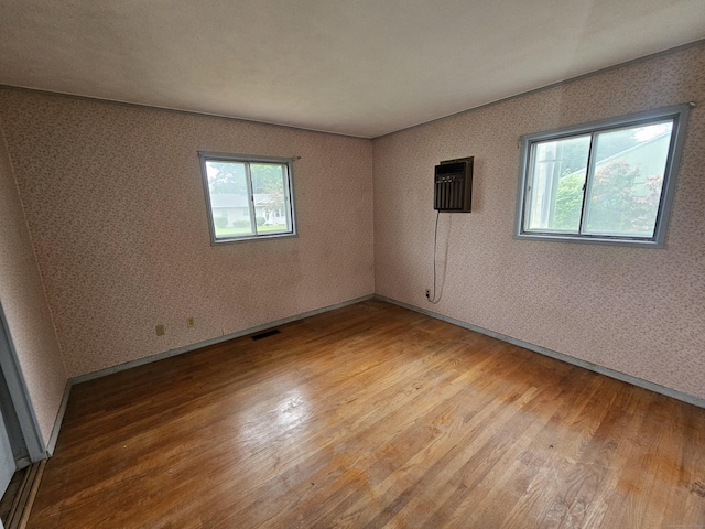 30 Hardwood Rd, Plainville, CT 06062 - unfurnished room with wood finished floors, a wall mounted AC, and baseboards