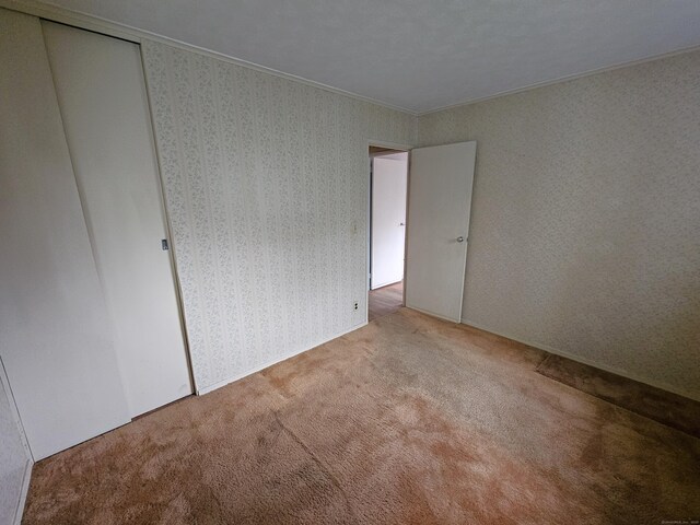 30 Hardwood Rd, Plainville, CT 06062 - carpeted spare room with crown molding and wallpapered walls