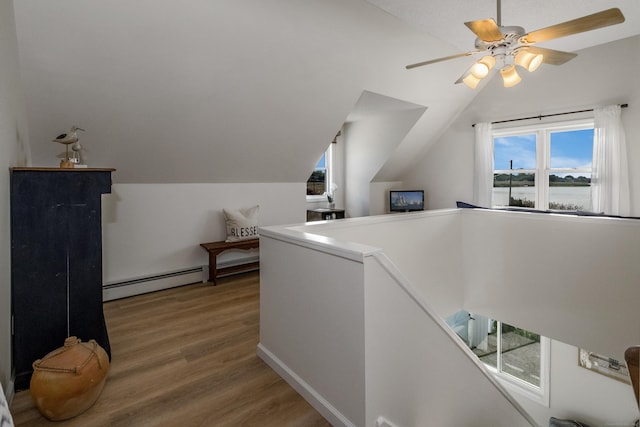 35 Soundview Ave, Old Saybrook, CT 06475 - corridor with a baseboard heating unit, lofted ceiling, wood finished floors, and an upstairs landing