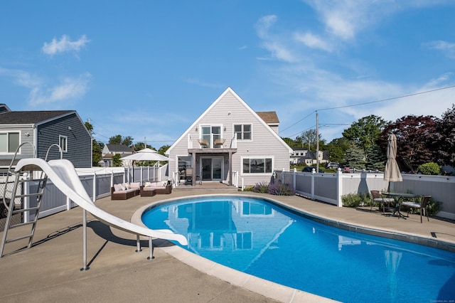 35 Soundview Ave, Old Saybrook, CT 06475 - view of swimming pool with a water slide, outdoor lounge area, a fenced backyard, and a patio