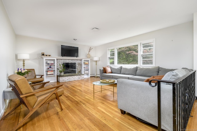 525 Bennetts Farm Rd, Ridgefield, CT 06877 - living area featuring light wood-type flooring, a baseboard radiator, and a fireplace