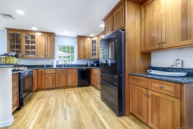 525 Bennetts Farm Rd, Ridgefield, CT 06877 - kitchen featuring black appliances, brown cabinetry, light wood-style floors, recessed lighting, and glass insert cabinets