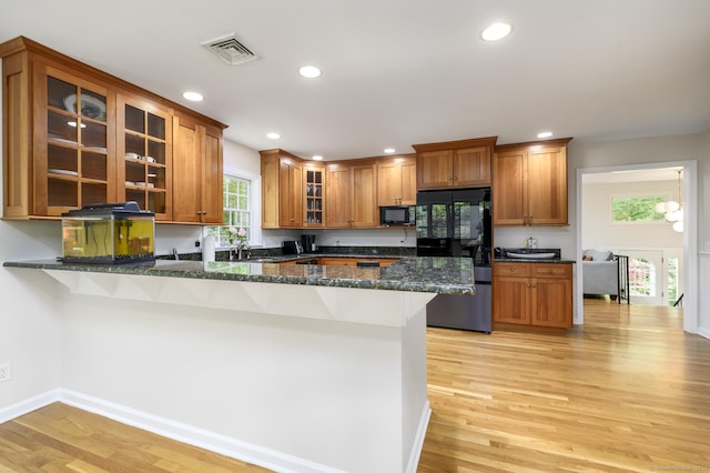 525 Bennetts Farm Rd, Ridgefield, CT 06877 - kitchen featuring refrigerator, black microwave, brown cabinetry, a breakfast bar area, and recessed lighting