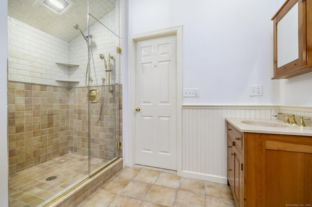 525 Bennetts Farm Rd, Ridgefield, CT 06877 - full bathroom featuring a stall shower, vanity, lofted ceiling, wainscoting, and tile patterned floors
