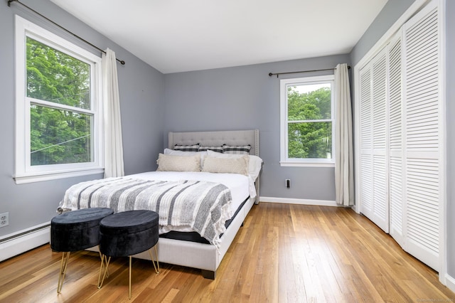 525 Bennetts Farm Rd, Ridgefield, CT 06877 - bedroom featuring light wood-style flooring, a baseboard heating unit, and baseboards