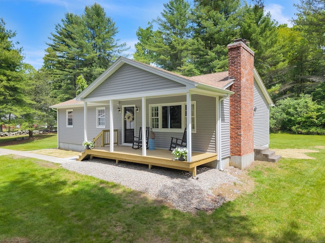 53 Pratt Rd, Plainfield, CT 06374 - view of front of property with a chimney, a front yard, a shingled roof, and a porch