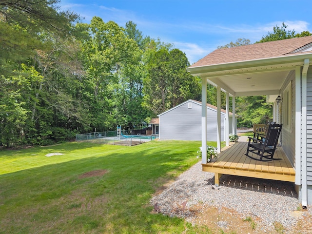 53 Pratt Rd, Plainfield, CT 06374 - view of green lawn featuring an outbuilding, a wooden deck, and an outdoor pool