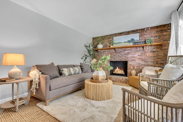 53 Pratt Rd, Plainfield, CT 06374 - living area featuring a brick fireplace, vaulted ceiling, brick wall, a textured ceiling, and light carpet
