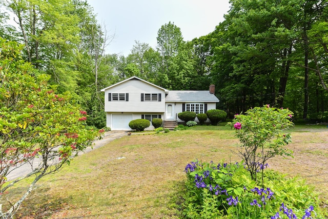 10 Meeting House Rd, Barkhamsted, CT 06063 - split level home featuring an attached garage, a chimney, driveway, and a front yard
