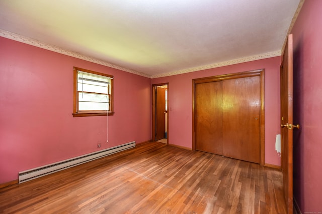 10 Meeting House Rd, Barkhamsted, CT 06063 - unfurnished bedroom with a baseboard radiator, light wood finished floors, and a closet