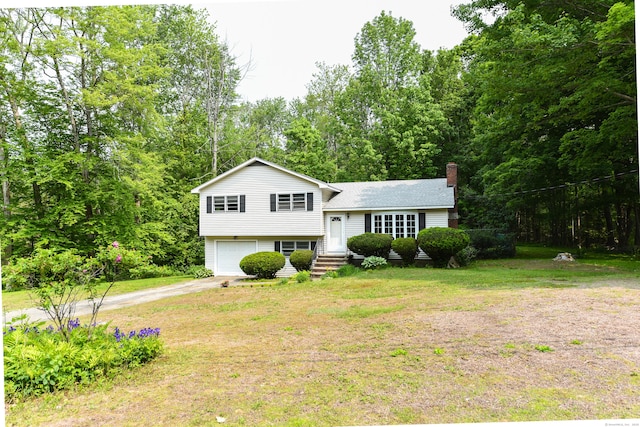 10 Meeting House Rd, Barkhamsted, CT 06063 - split level home with dirt driveway, a garage, a chimney, a front lawn, and a shingled roof