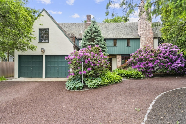 20 Cook Rd, Stamford, CT 06902 - tudor home featuring a chimney and a garage