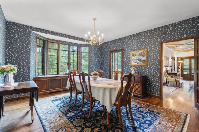20 Cook Rd, Stamford, CT 06902 - dining room with wallpapered walls, a chandelier, hardwood / wood-style flooring, and plenty of natural light
