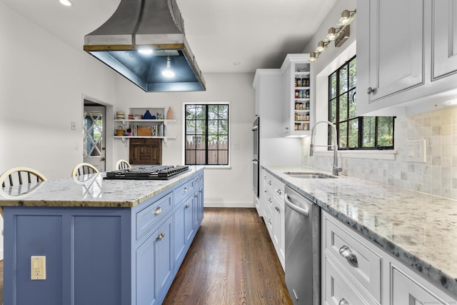 20 Cook Rd, Stamford, CT 06902 - kitchen with a sink, appliances with stainless steel finishes, wall chimney range hood, dark wood-style flooring, and blue cabinetry