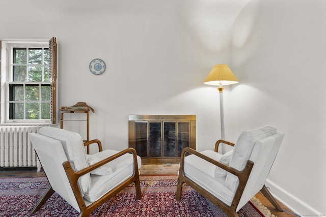 20 Cook Rd, Stamford, CT 06902 - sitting room with a glass covered fireplace, radiator heating unit, and wood finished floors