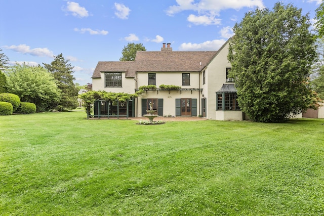 20 Cook Rd, Stamford, CT 06902 - back of house featuring stucco siding, a yard, and a chimney