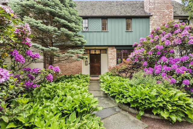 20 Cook Rd, Stamford, CT 06902 - view of front of house featuring board and batten siding, brick siding, and a chimney