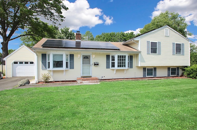 537 Hobart St, Southington, CT 06489 - view of front facade with a chimney, a front lawn, a garage, and solar panels
