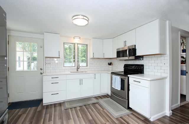 537 Hobart St, Southington, CT 06489 - kitchen featuring stainless steel appliances, a sink, light countertops, dark wood-style floors, and a textured ceiling