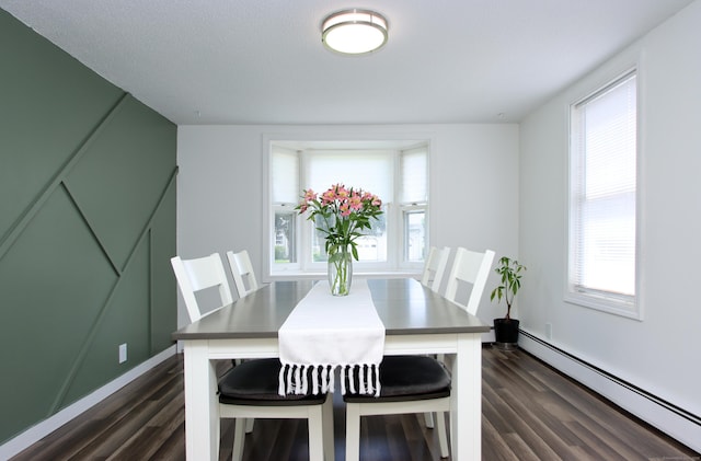 537 Hobart St, Southington, CT 06489 - dining area featuring a baseboard heating unit, dark wood-style flooring, and plenty of natural light