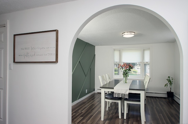 537 Hobart St, Southington, CT 06489 - dining room featuring a textured ceiling, dark wood-style floors, a baseboard radiator, and arched walkways