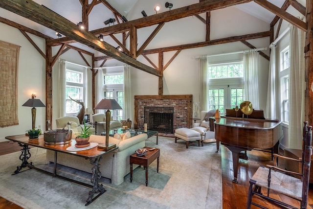 88 Hemlock Rd, Roxbury, CT 06783 - living area featuring high vaulted ceiling, a brick fireplace, wood finished floors, and beam ceiling