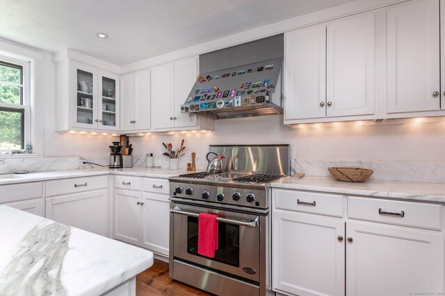 88 Hemlock Rd, Roxbury, CT 06783 - kitchen with high end stainless steel range oven, white cabinets, glass insert cabinets, wood finished floors, and recessed lighting