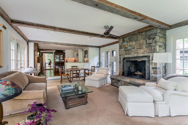 88 Hemlock Rd, Roxbury, CT 06783 - living area with beamed ceiling, ceiling fan, light colored carpet, a fireplace, and french doors