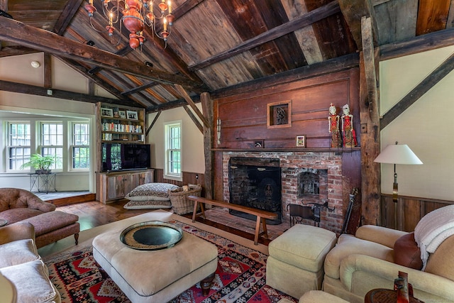 88 Hemlock Rd, Roxbury, CT 06783 - living area with a brick fireplace, wooden walls, wood finished floors, a wainscoted wall, and a chandelier