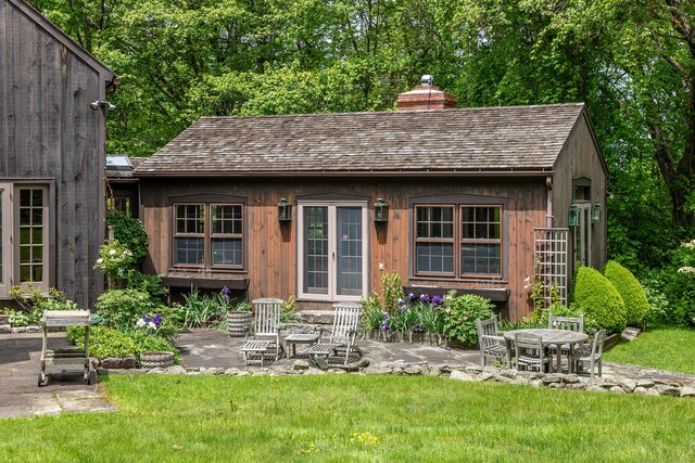 88 Hemlock Rd, Roxbury, CT 06783 - back of house with a chimney, a lawn, and a patio