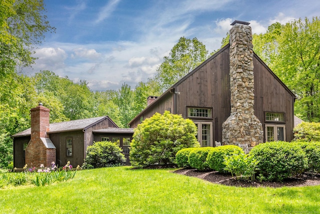 88 Hemlock Rd, Roxbury, CT 06783 - view of side of home with a chimney and a lawn