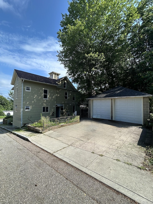 51 Division St, Norwich, CT 06360 - view of property exterior with an outdoor structure and a detached garage
